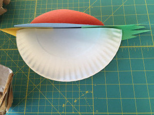 Attaching bird to paper plate Attaching bird to paper plate